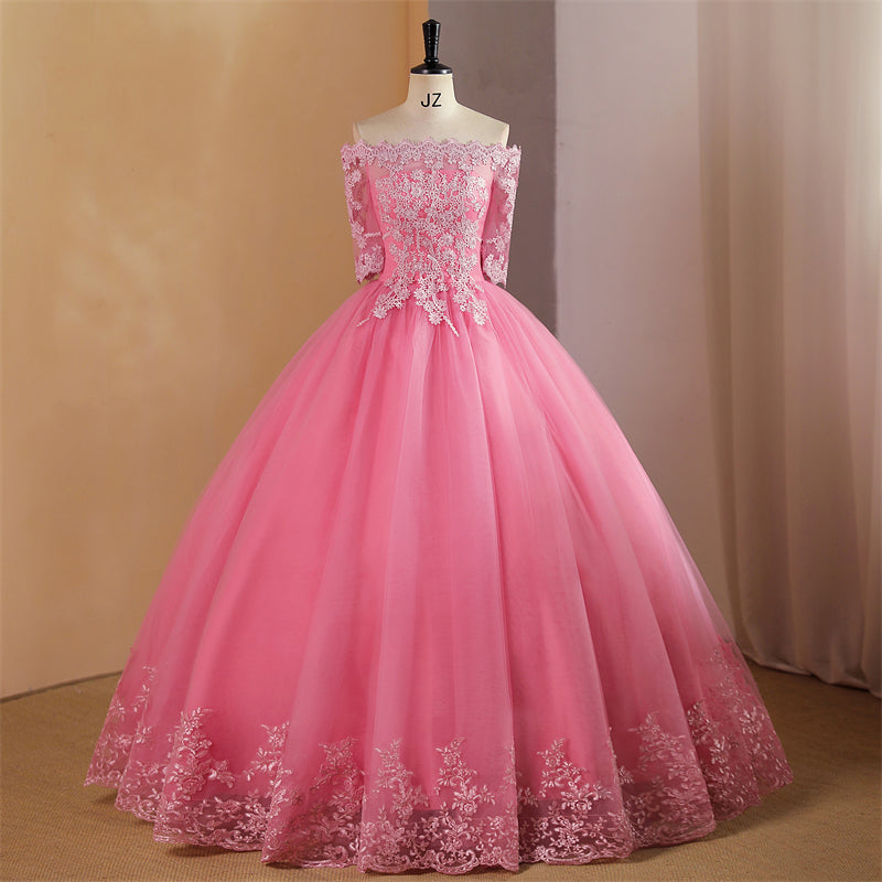 A pink ball gown off-the-shoulder graduation party dress with floral lace applique and embroidery, displayed on a mannequin.