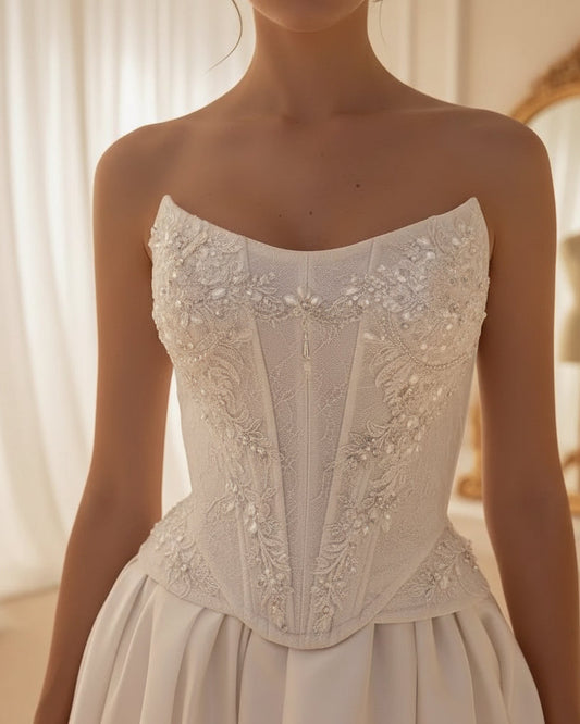 White satin bridal dress with lace corset bodice, sweetheart neckline, and flowing slit skirt