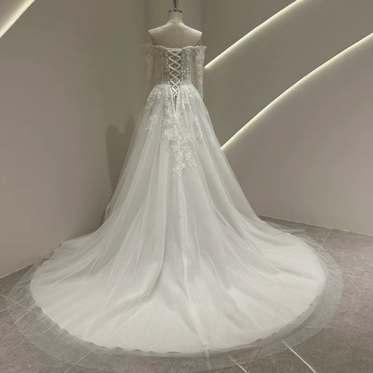 Ivory lace wedding dress with lace corset bodice, crisscross back lacing, and tulle skirt