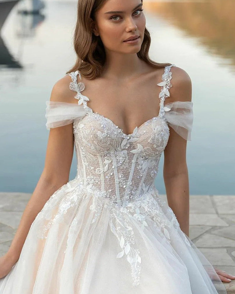 Ivory off-shoulder lace corset wedding dress bodice with floral appliques and sparkle