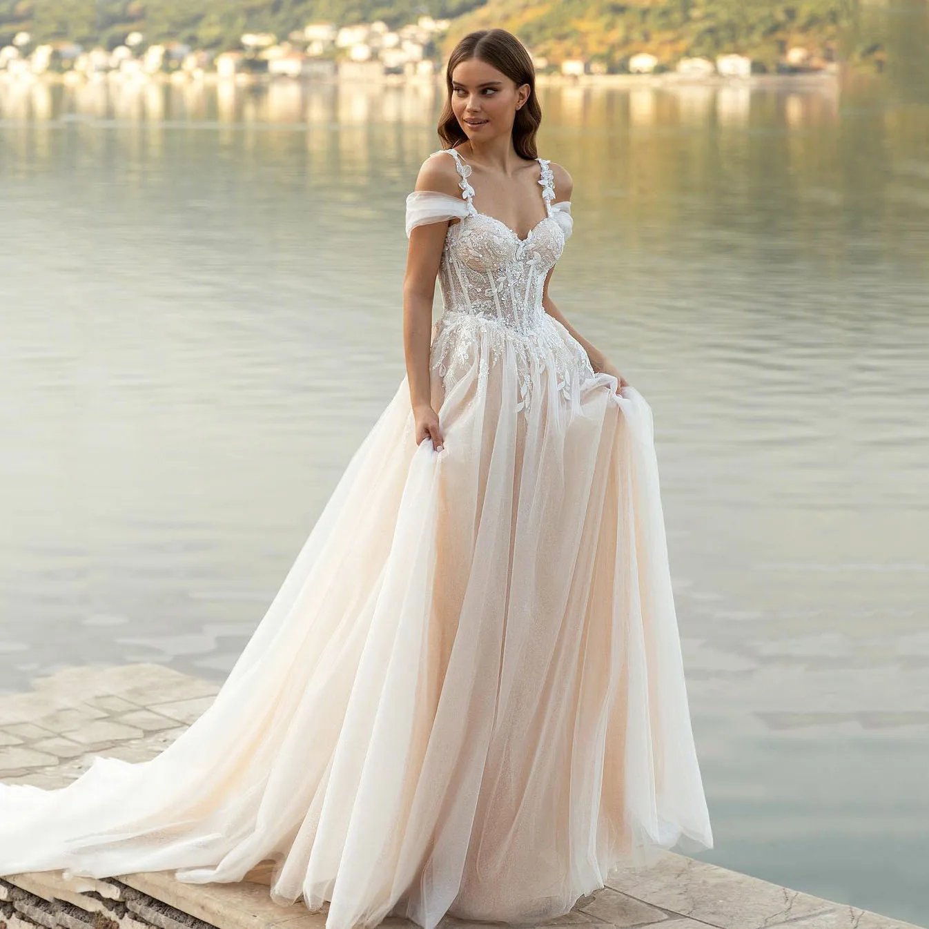 Corset style sweetheart neckline made in lace. Champagne colour lining with ivory tulle top layer beach wedding dress.