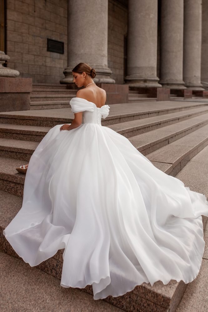 Off the shoulder white organza wedding dress with a beautiful voluminous train