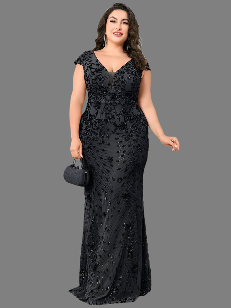 A woman in a plus size black sequin evening formal party dress with a mermaid silhouette and cap sleeves.