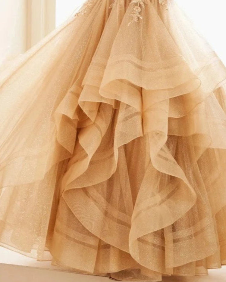 Beige glitter tulle skirt of a formal party dress with layered ruffle tiers