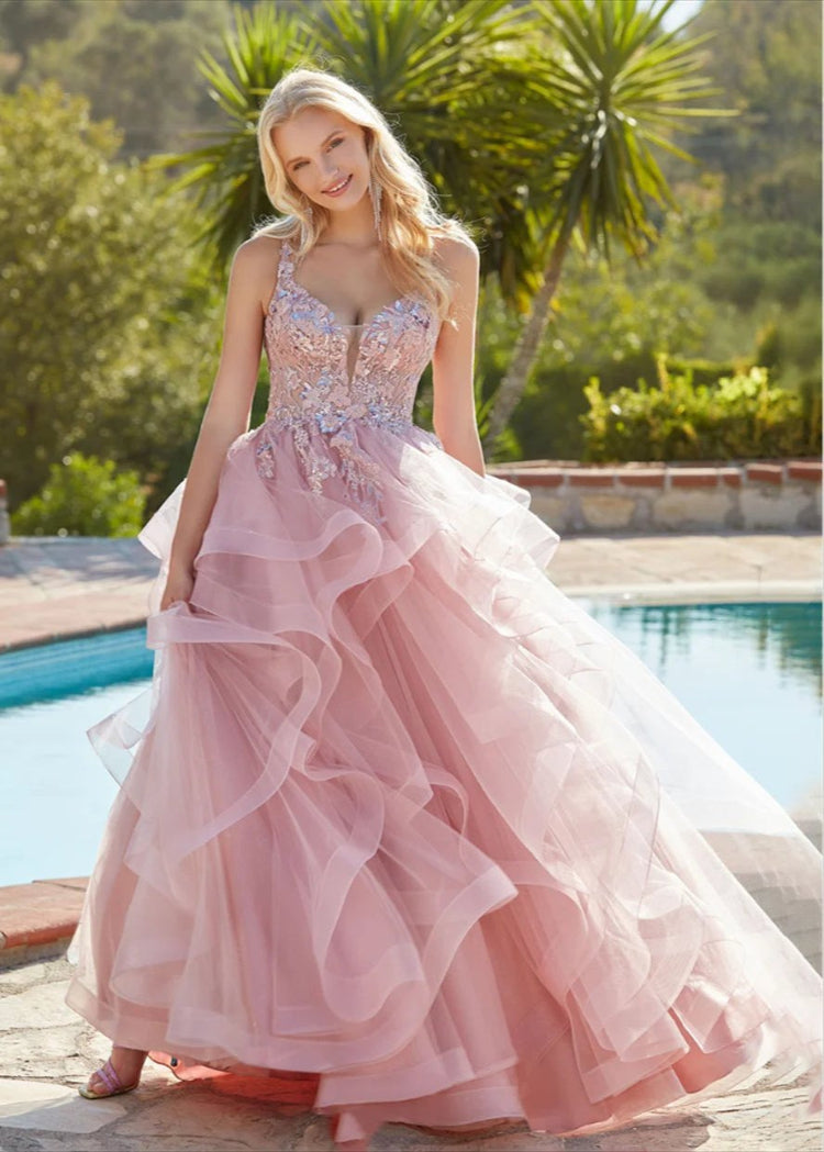 pink fluffy multi layered tulle with beading party dress. Spaghetti straps with a v-neckline bodice with lace embroidery.