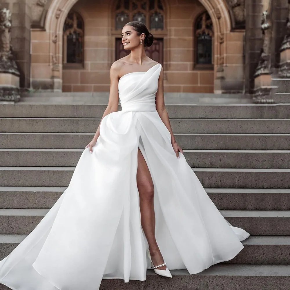 white strapless design organza a-line wedding dress sizes 2-26W. Alluring front leg split with a beautiful sweep train.