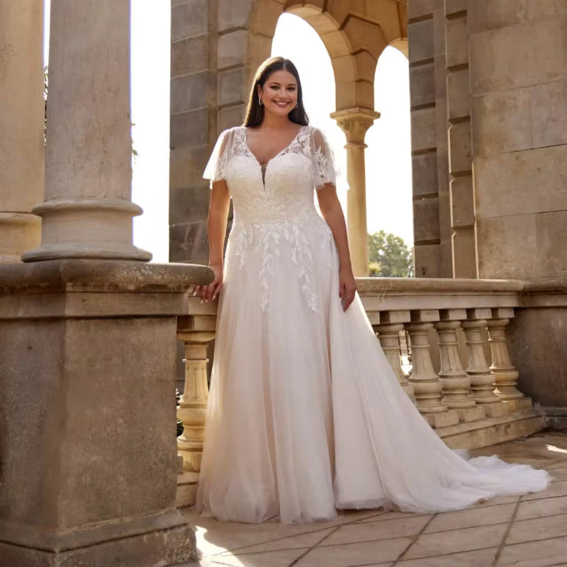 Ivory A-line lace wedding dress with V-neck, sheer sleeves, and full flowing skirt