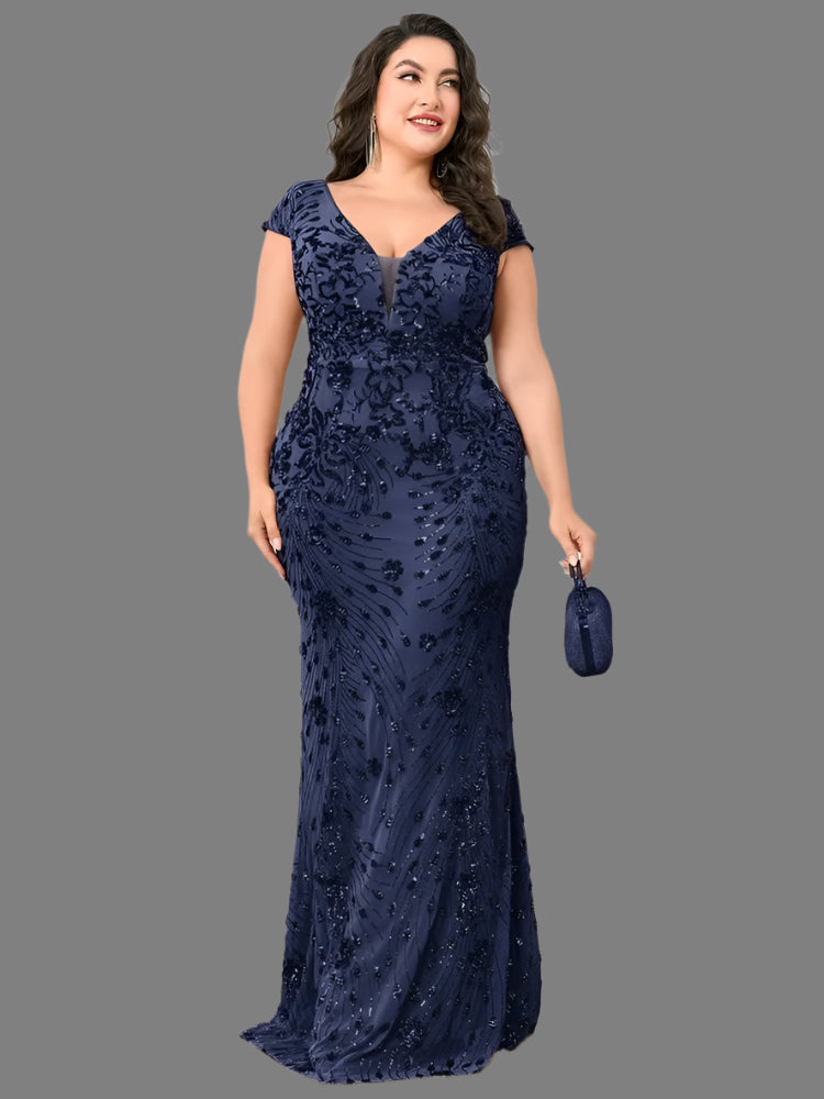 A woman in a plus size elegant navy sequin evening formal party dress with a mermaid silhouette and cap sleeves.
