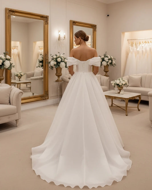 White off-shoulder corset bridal gown with off-shoulder sleeves and full A-line skirt