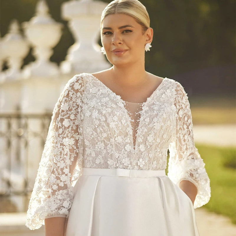 White lace bodice wedding dress with satin skirt, V-neck, and long sleeves