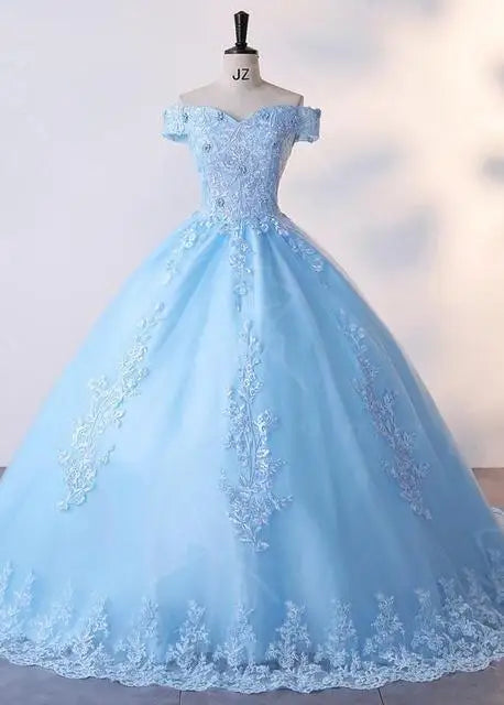 A sky blue lace luxury ball gown with a natural waistline and lace-up back on a mannequin.