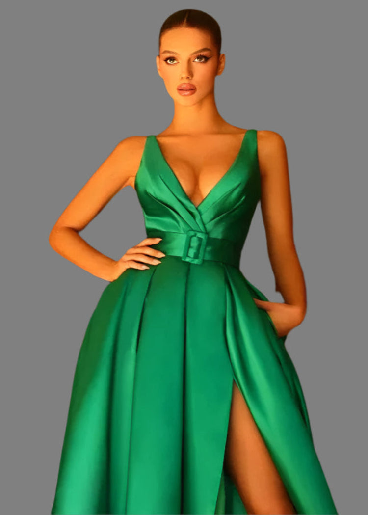 Model wearing a green satin v-neck evening gown on a gray background