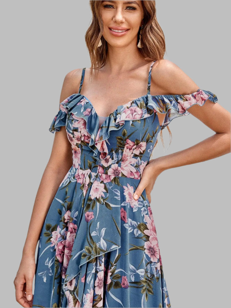 Woman wearing a blue floral dress against a white background