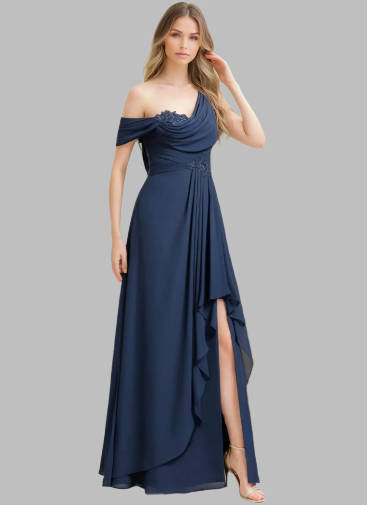 Woman wearing a navy blue one-shoulder dress with a slit, standing against a neutral background.