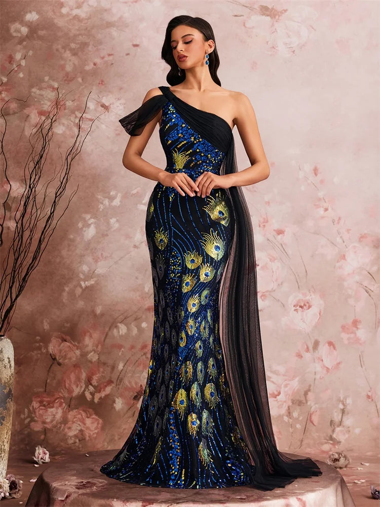 Woman wearing a one-shoulder evening gown with floral embroidery against a floral background