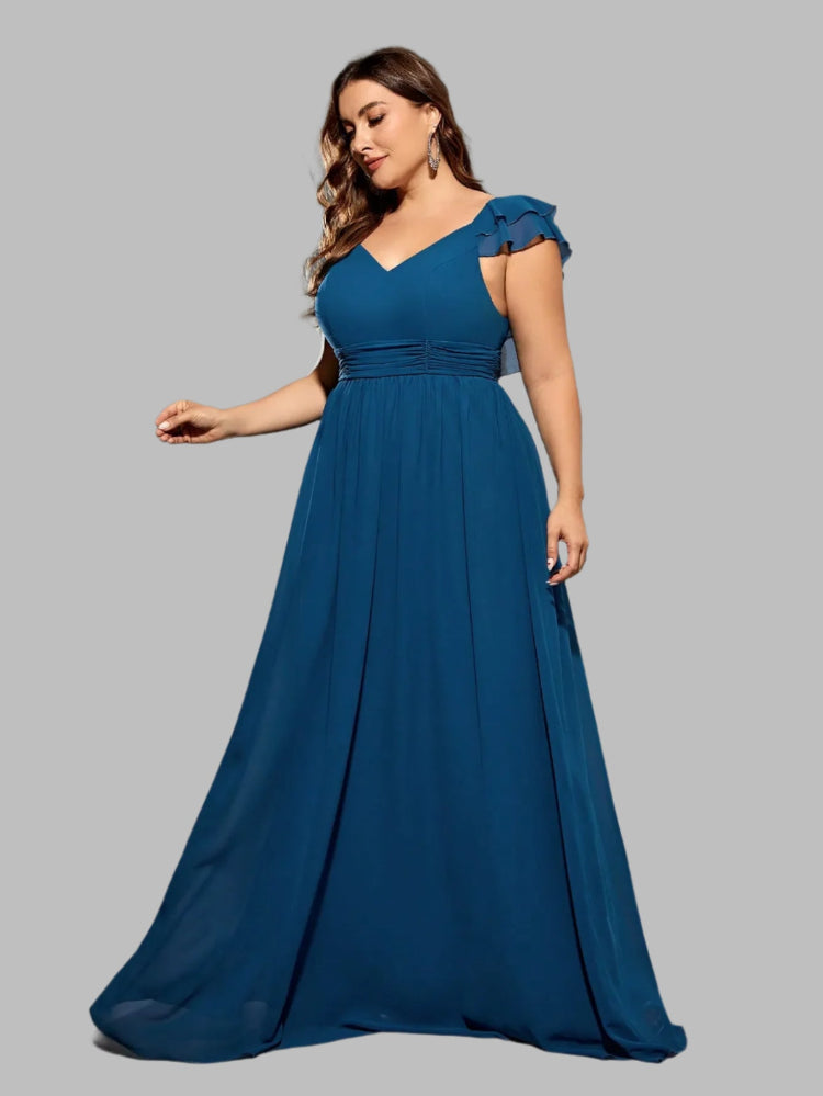 Woman wearing a blue evening gown on a gray background