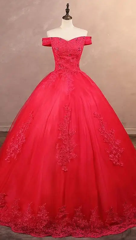 A red off-the-shoulder applique lace luxury ball gown with a natural waistline and lace-up back on a mannequin.
