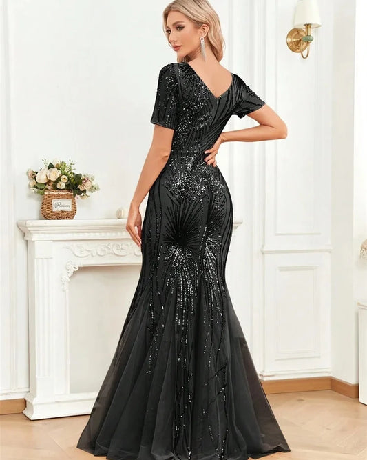 Black sequined mermaid dress with short sleeves and fitted waist, flared hem