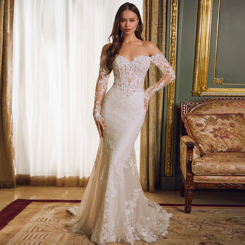 Champagne colour lining in this mermaid ivory lace wedding dress. Illusion lace corset style strapless neckline with long sleeves and a sweep train.