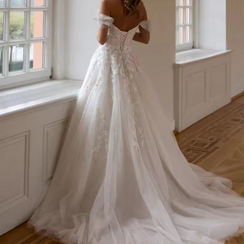 Off-shoulder lace wedding dress with floral bodice and full A-line skirt
