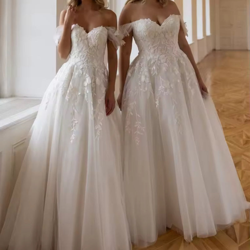 Off-shoulder lace A-line wedding dress with floral detailing and tiered tulle skirt