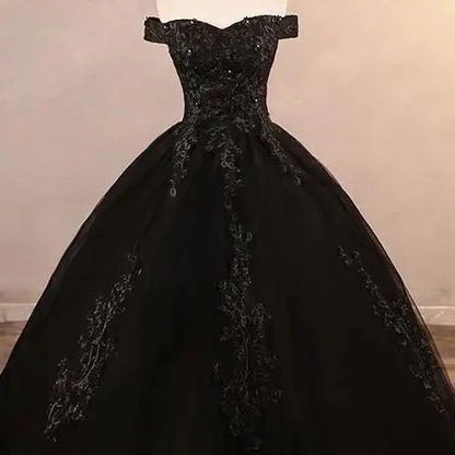 Off-shoulder lace ball gown with dark lace bodice and full skirt, black tone.