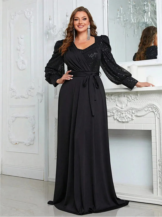 Plus size black V-neck evening dress with long sleeves, sequin accents, and waist tie