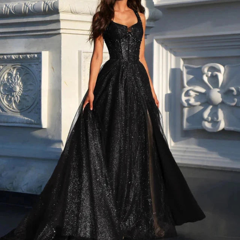 Black A-line glitter tulle formal dress with wide straps and full flowing skirt