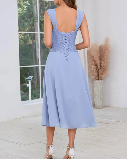 Light blue two-piece chiffon dress from back with crisscross laced bodice detail