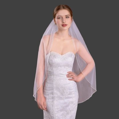 Bridal soft tulle veil with crystal beaded edge, draped over shoulders