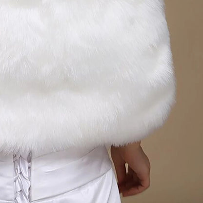 Off-white faux fur shawl close-up with soft pile and satin tie detail