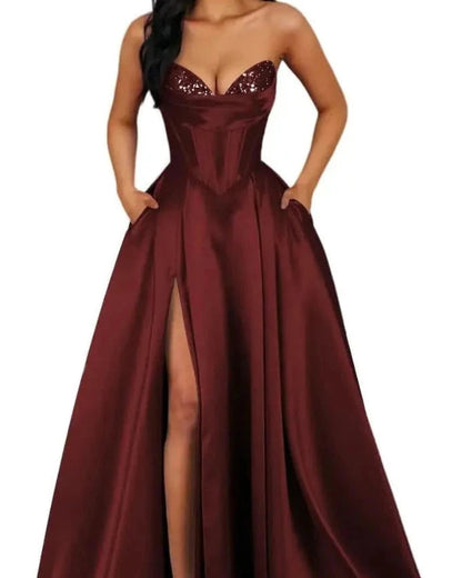 Burgundy strapless A-line satin dress with sequin bust and thigh-high slit