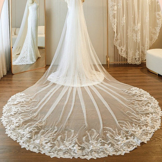 Ivory single-tier cathedral veil with floral lace border and flowing pleated tulle edge