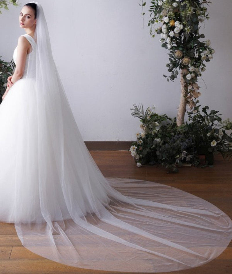 Cathedral bridal veil in white sheer tulle, plain cut edge, side drape