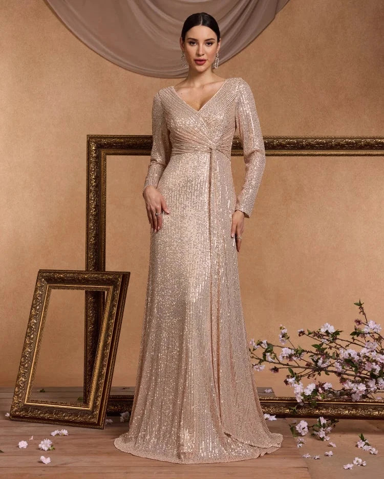 Champagne sequin long-sleeve maxi dress with V-neck and ruched center waist.
