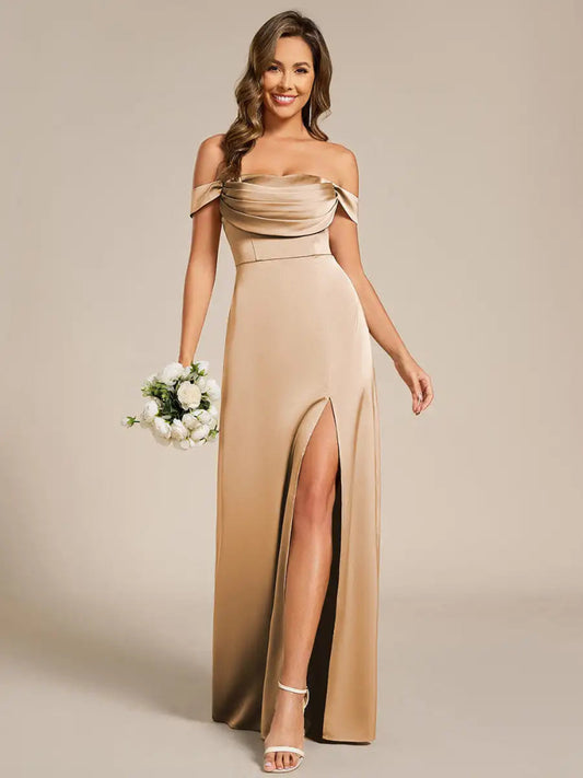 Woman wearing an A-line satin strapless dress. Pleated bodice and floor length with leg split bridesmaid dress