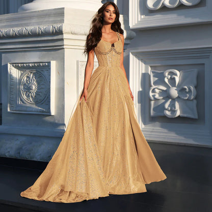 Gold A-line glitter tulle formal dress with wide straps and fitted corset-style bodice