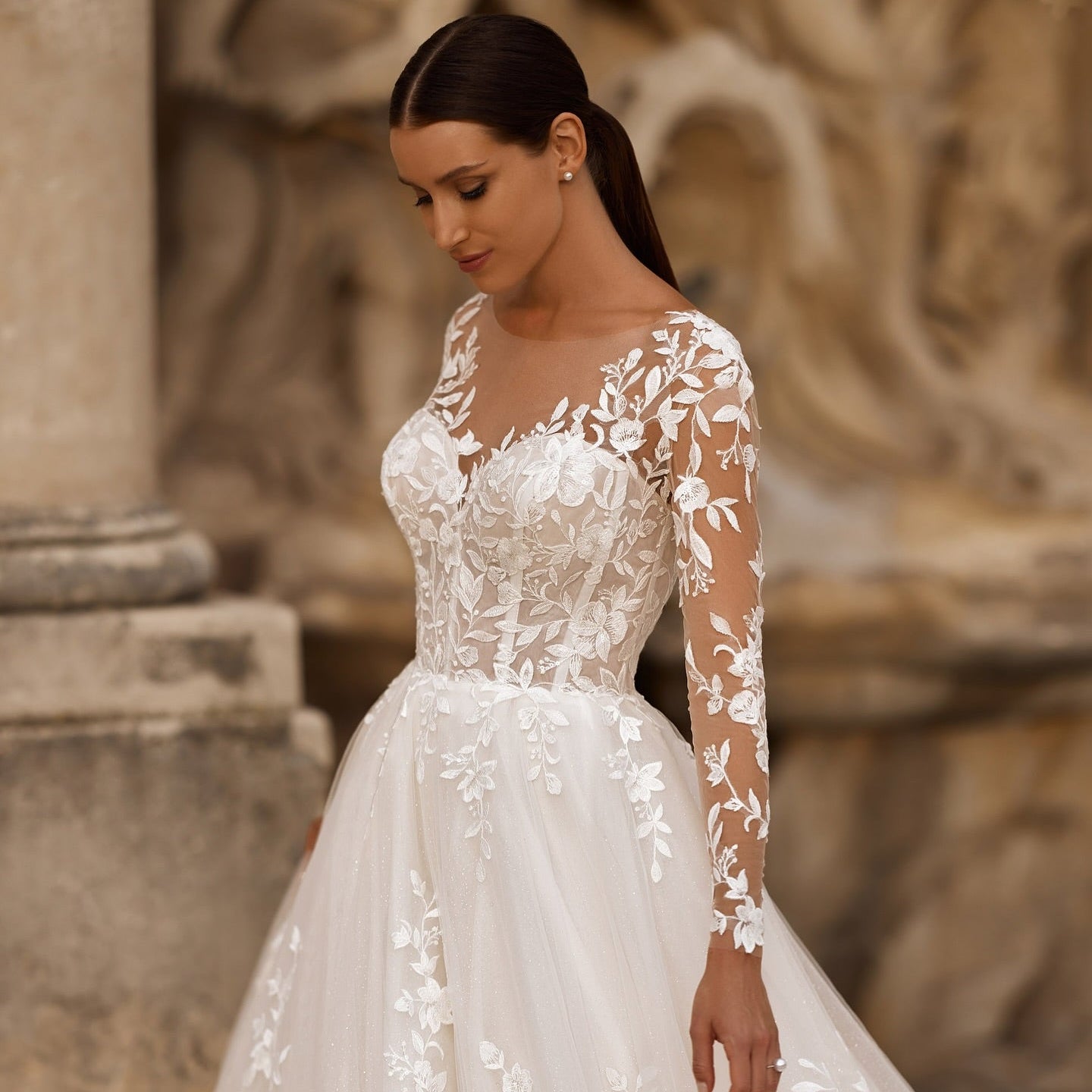 White illusion lace wedding dress with floral sleeves and embroidered bodice, full skirt