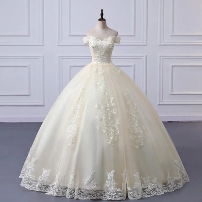 Off-shoulder lace ball gown with fitted bodice and full A-line skirt, ivory tone.