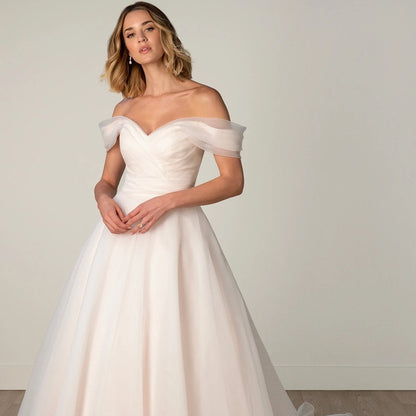 Pink organza a-line style with an off the shoulder pleated bodice. All sizes 2-26w available 