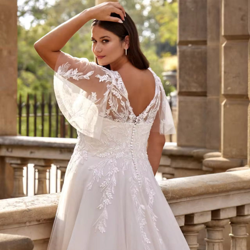 Ivory A-line lace wedding dress with V-neckline and floral appliqué on the bodice