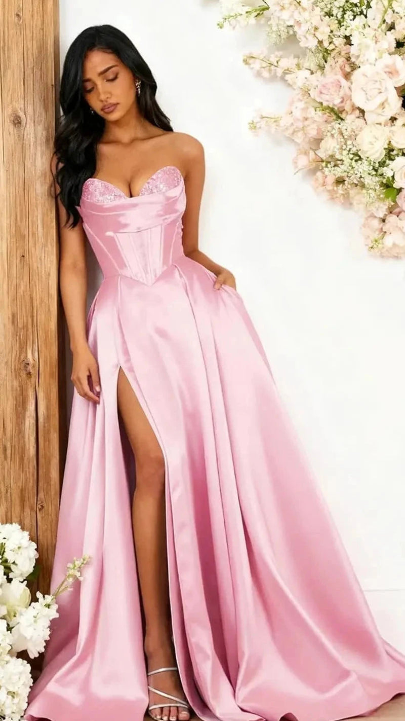 Strapless A-line satin dress with sequin bust and front slit, light pink.