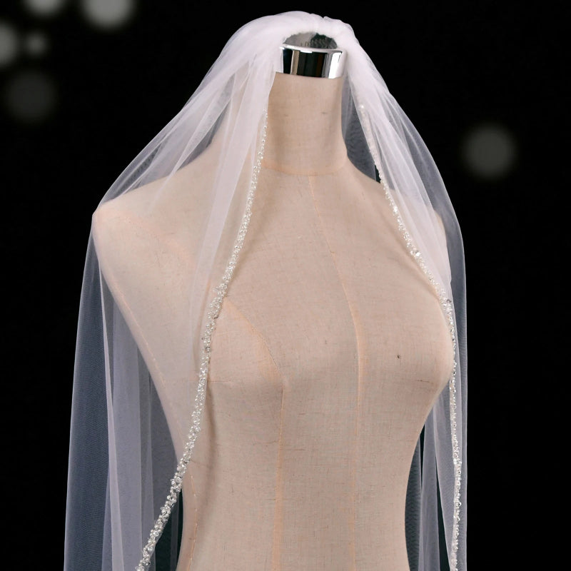 Ivory single-tier cathedral wedding veil with beaded border, shown on mannequin