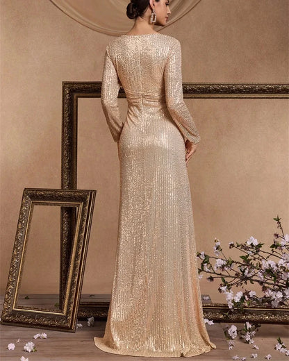 Champagne sequin long-sleeve maxi dress from the back with full-length skirt.