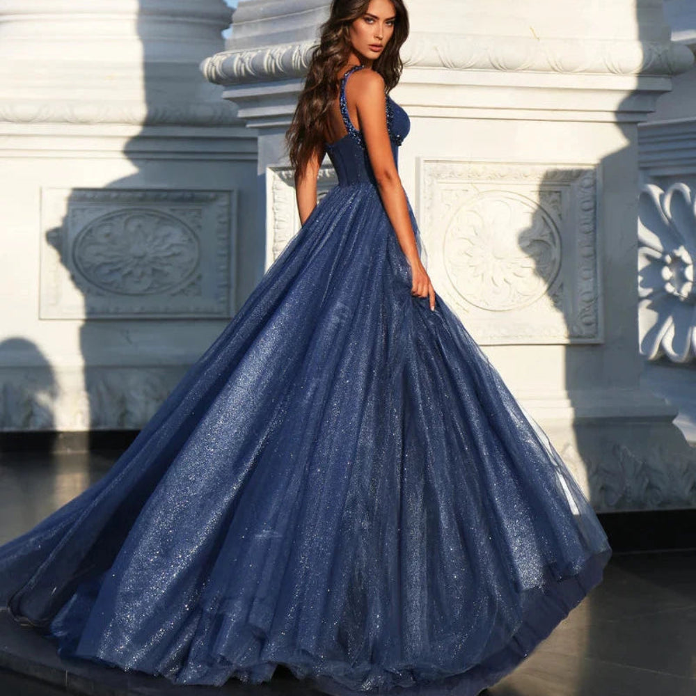Blue A-line glitter tulle formal dress with wide straps and full flowing skirt