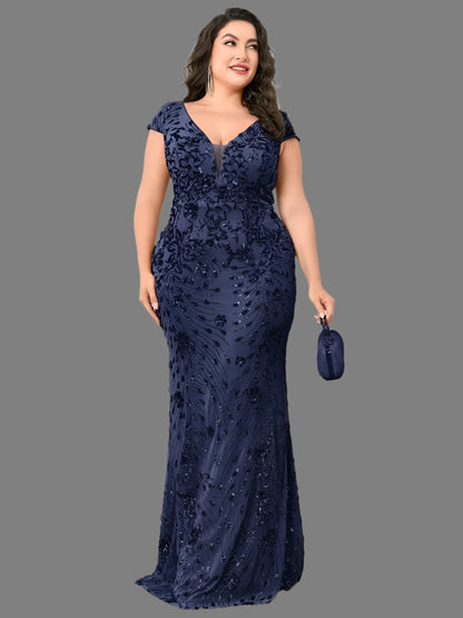 A woman in a plus size elegant navy sequin evening formal party dress with a mermaid silhouette and cap sleeves.