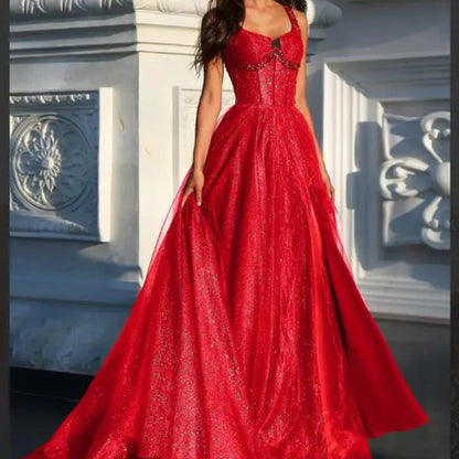 Red A-line glitter tulle formal dress with wide straps and full flared skirt