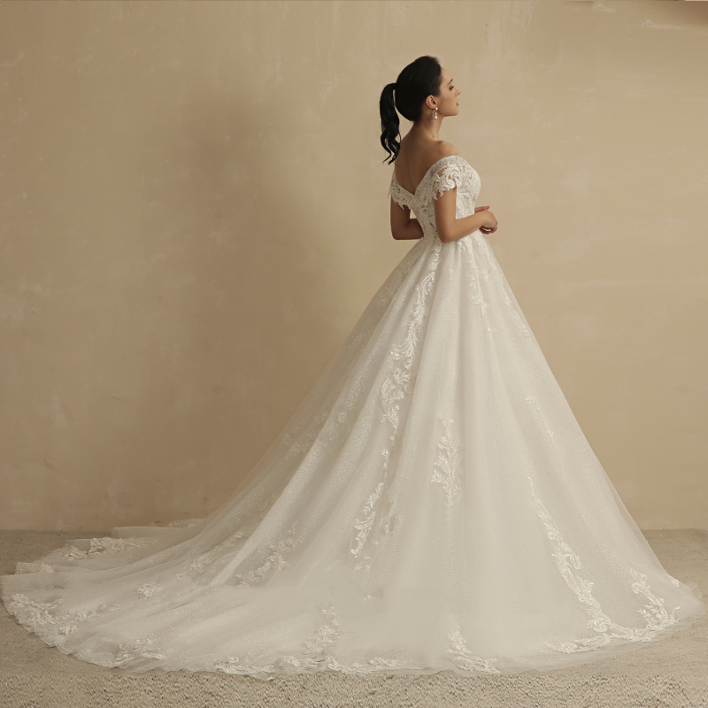 Ivory off-shoulder lace princess wedding dress with airy skirt and embroidered details