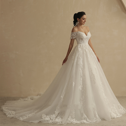 Ivory off-shoulder lace princess wedding dress with fitted bodice and long flowing train