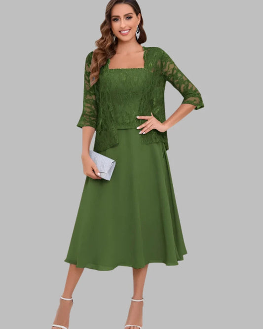 Woman wearing a green lace dress with a plain background